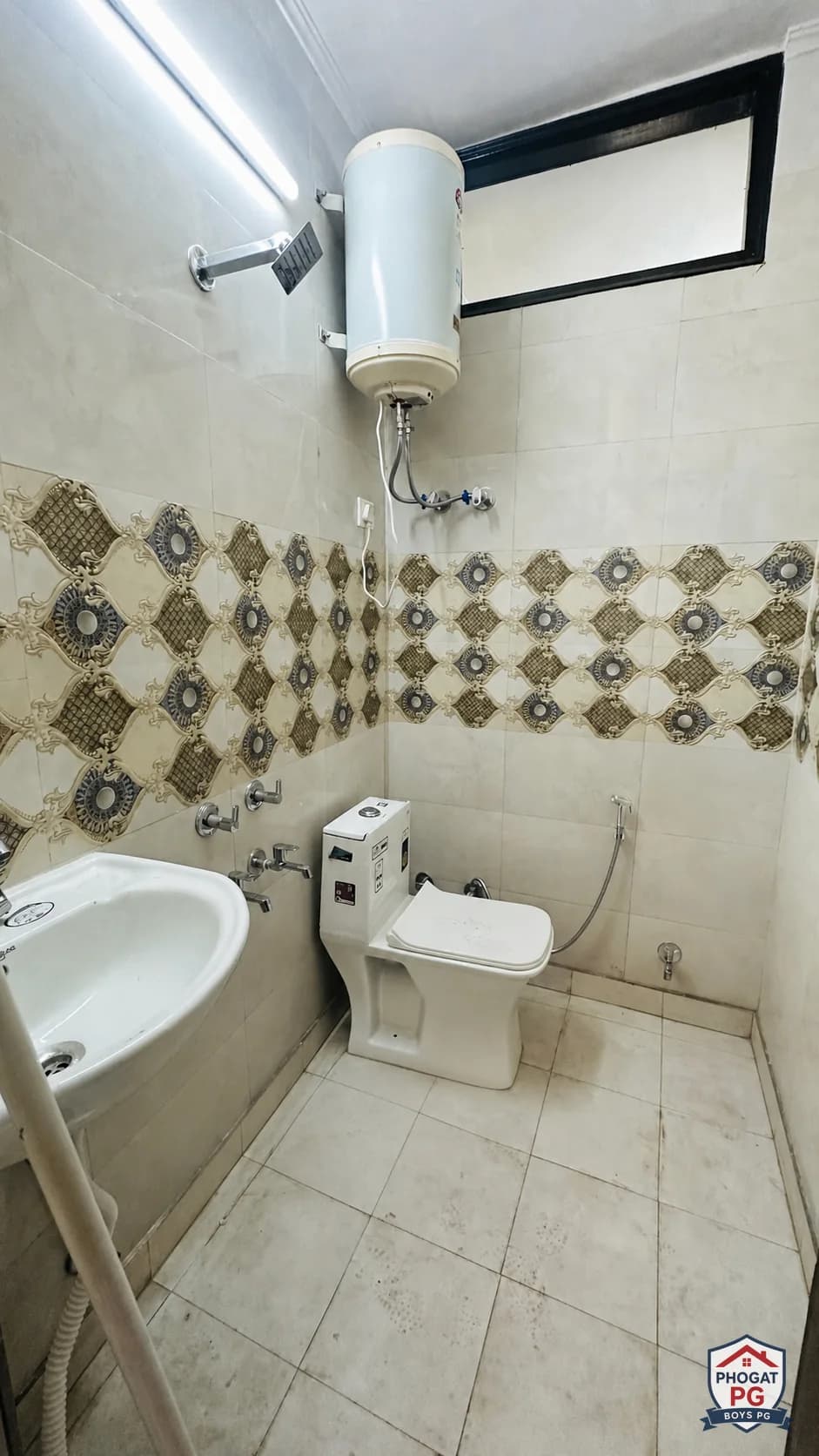 Bathroom with toilet, sink, shower and wall-mounted water heater at Phogat PG