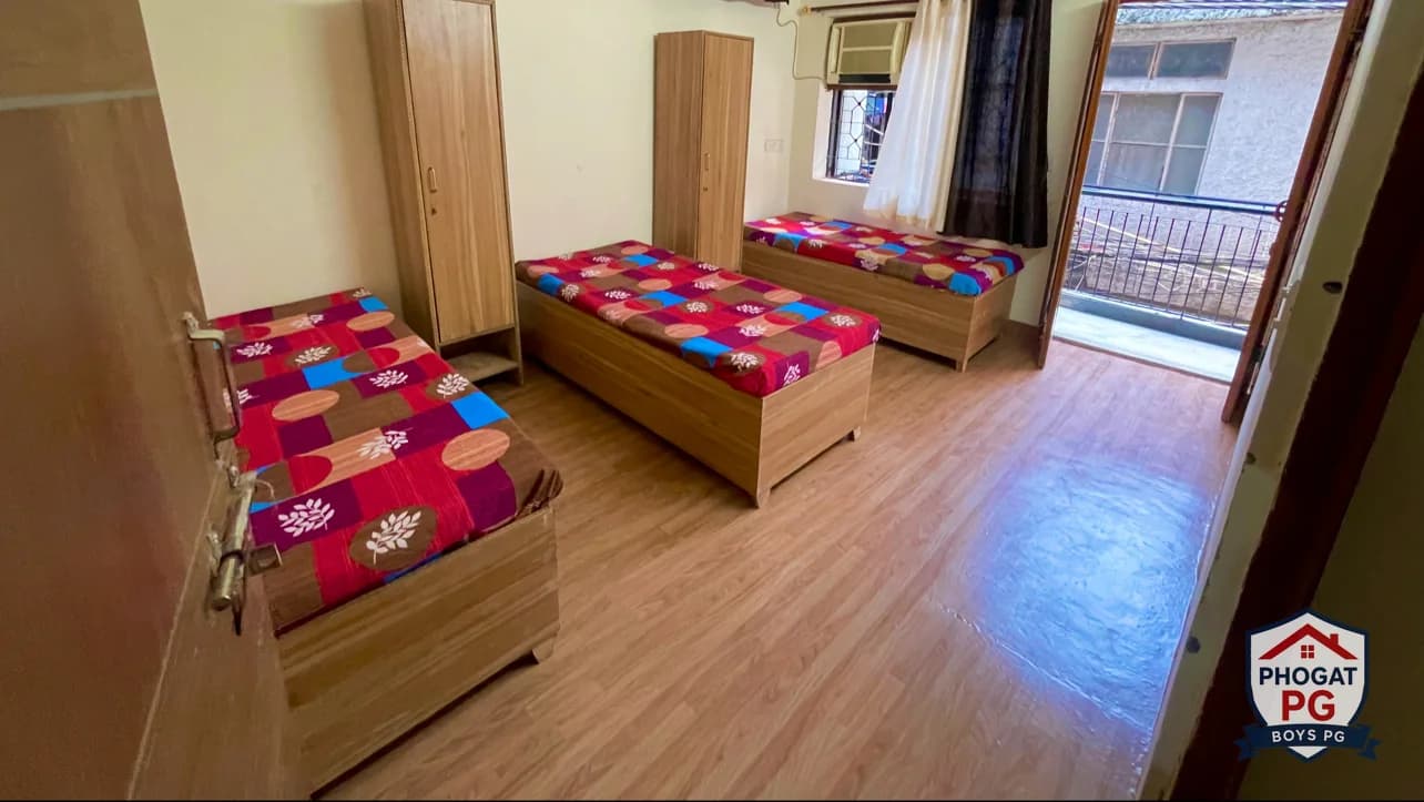 Three beds, wardrobes and balcony access in a Phogat PG room