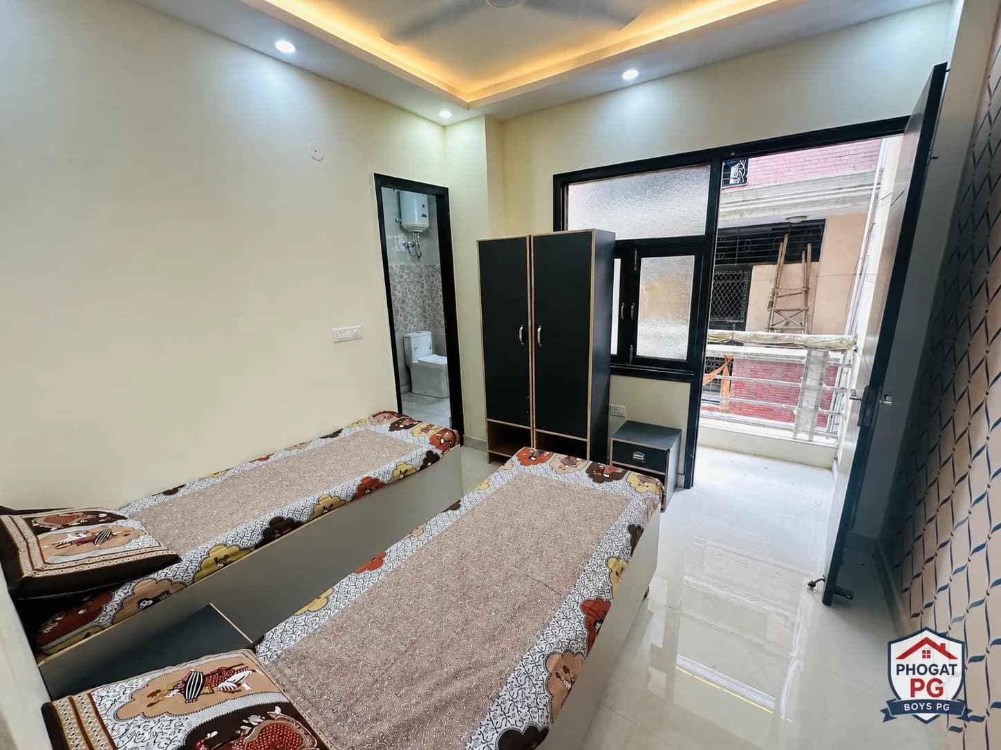 Two single beds, wardrobes, bathroom doorway and balcony access in a Phogat PG room